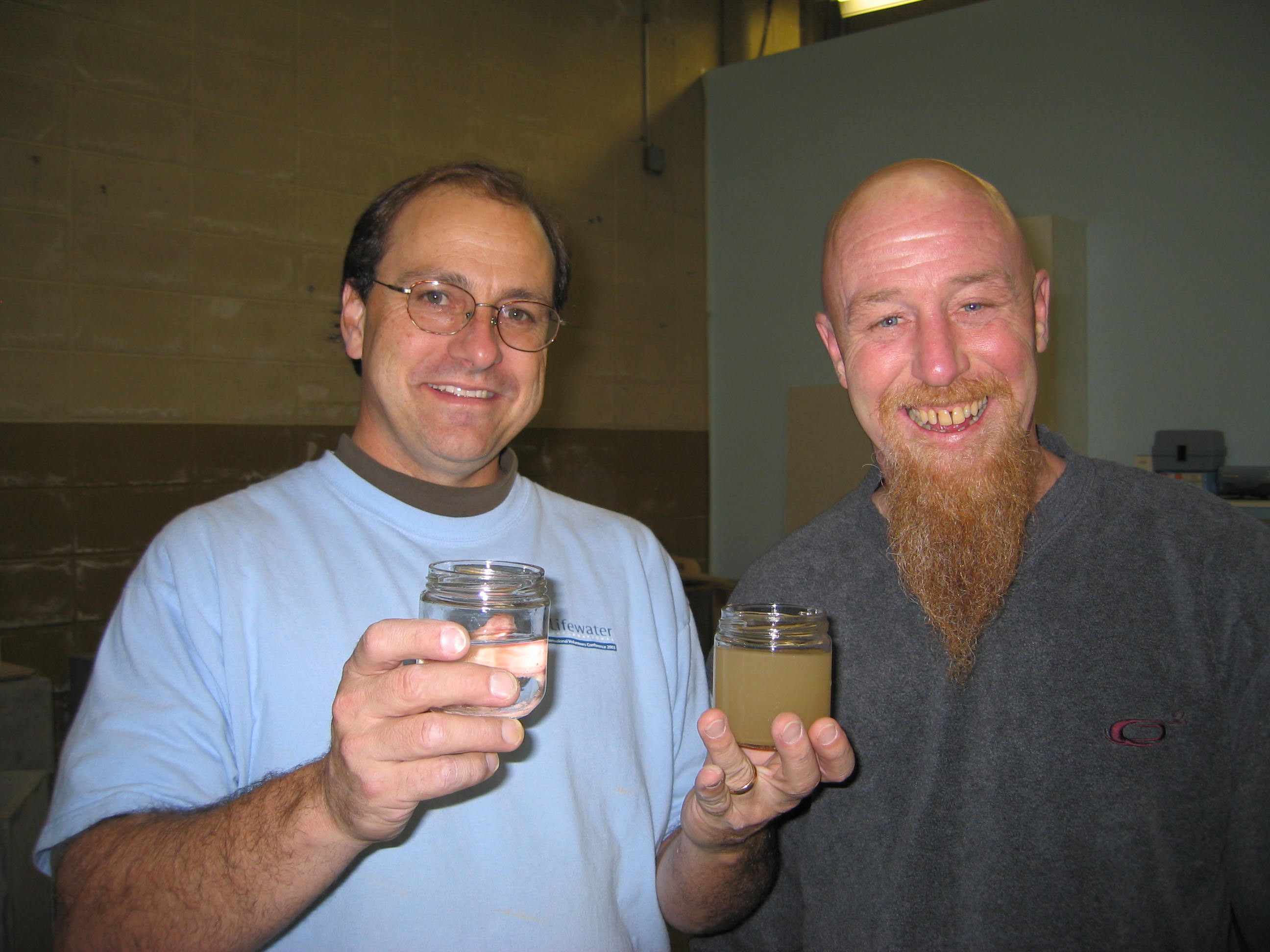 Kirk Schauer and Tal Woolsey demonstrate sand filters cleaning ability